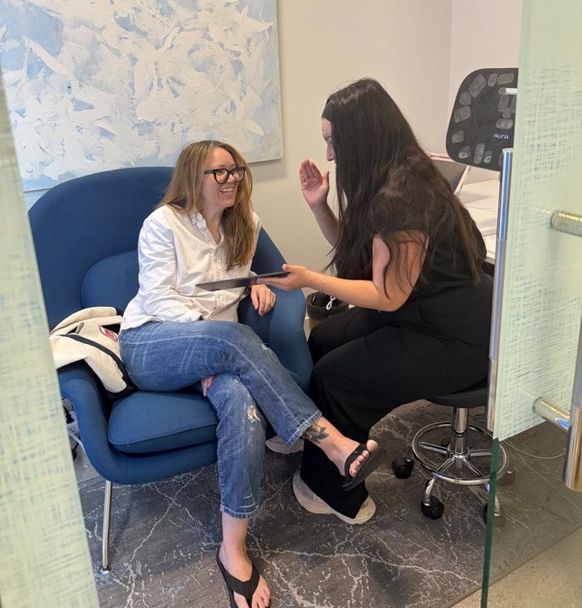 Provider and patient discussing skin analysis at Revival Dermatology